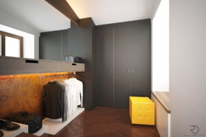 Walk-in wardrobe with dark grey cabinetry, wooden floor, illuminated orange accent wall, and a yellow leather ottoman